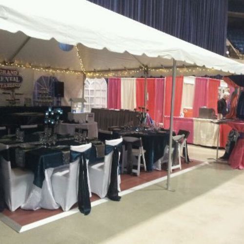 Table and chair set up under an event tent