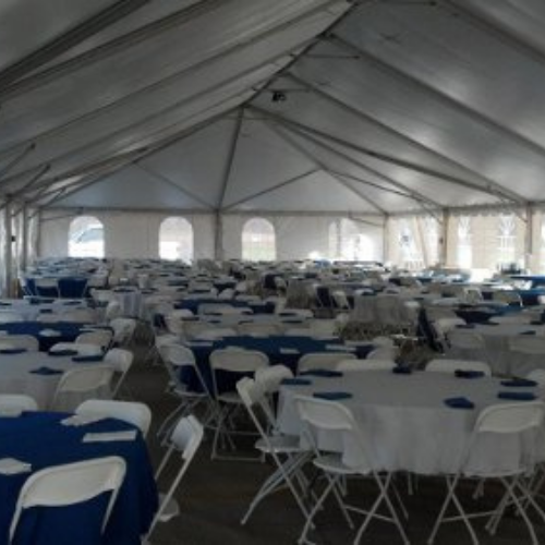 Table and chair set up under an event tent