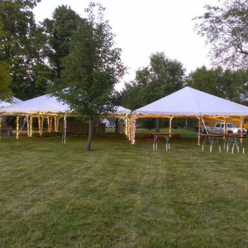 Tables set up under an event tent outside
