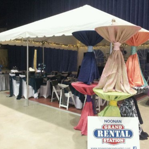 Table and chair set up under an event tent