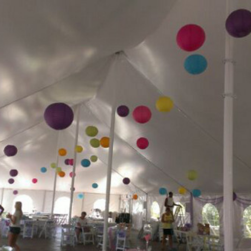 Table and chair set up under an event tent