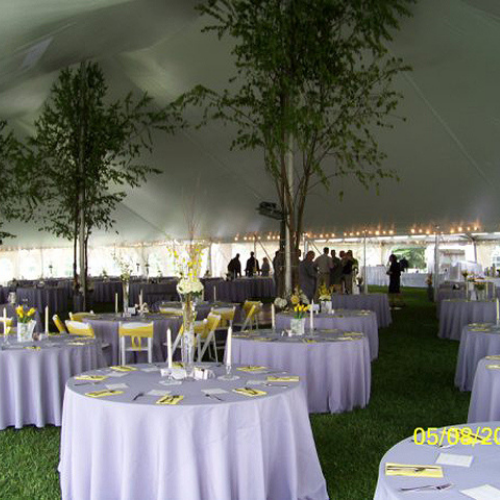 Table and chair set up under an event tent