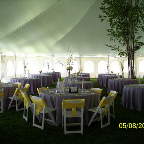 Table and chair set up under an event tent