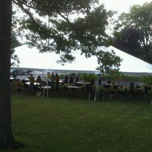 Table and chair set up under an event tent