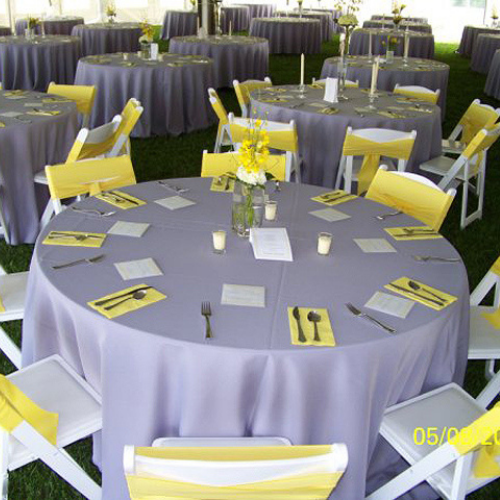 Table and chair set up under an event tent