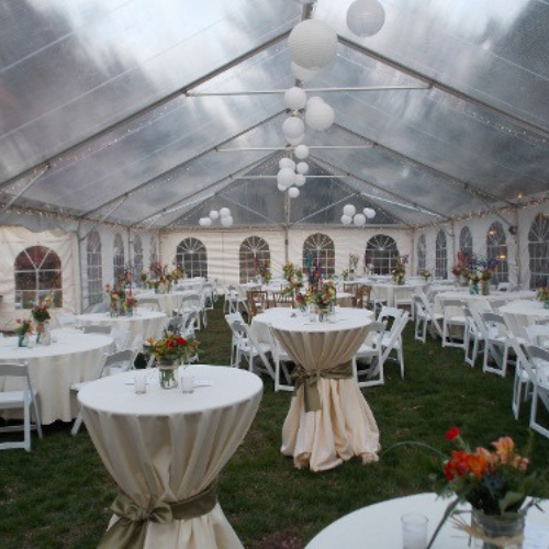 Table and chair set up under an event tent