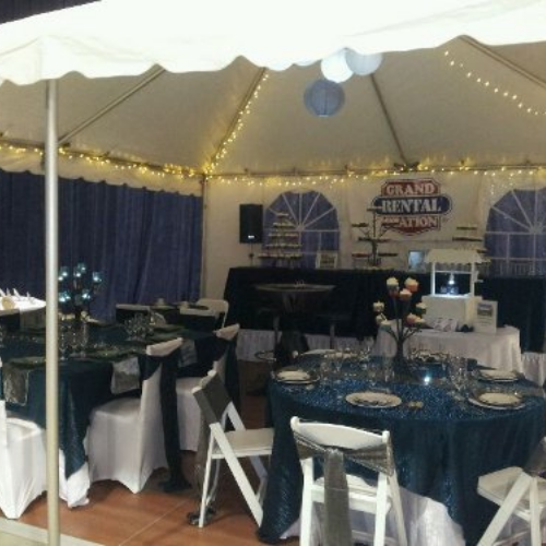 Table and chair set up under an event tent