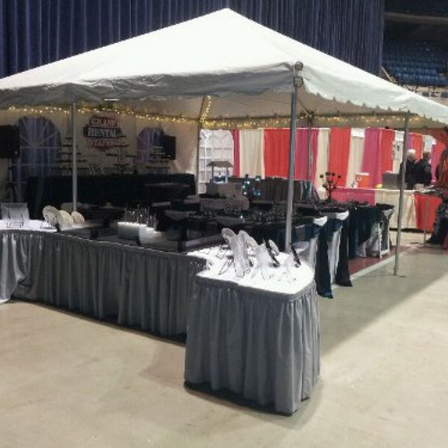 Table and chair set up under an event tent